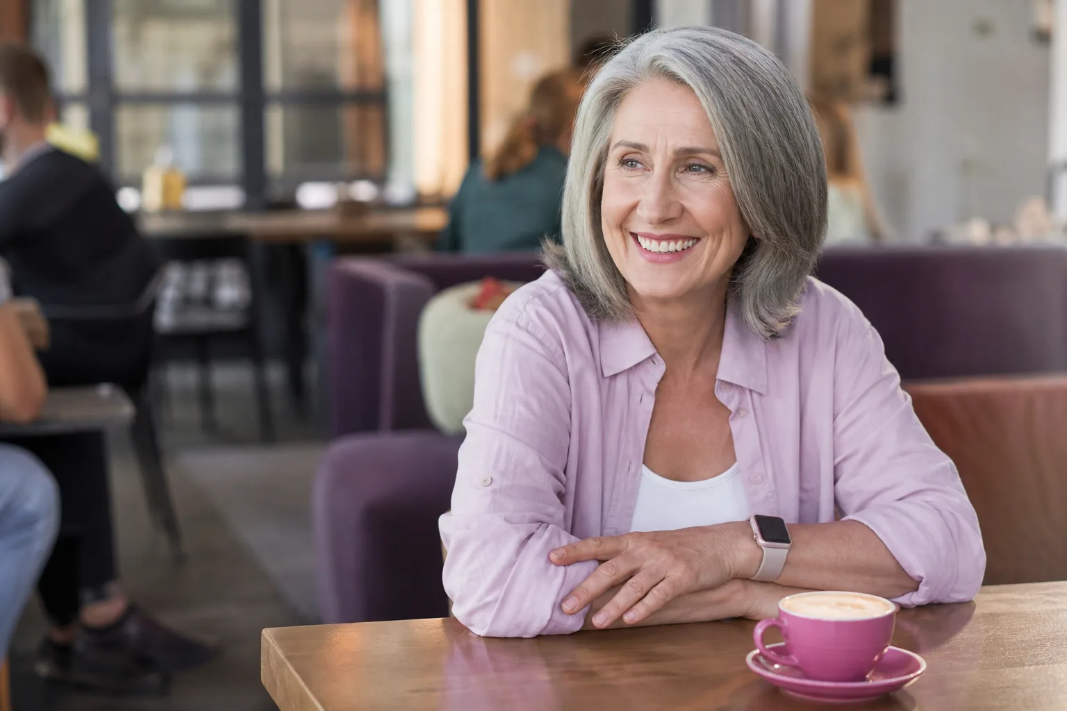 Mature Auckland woman enjoying coffee beside the waterfront