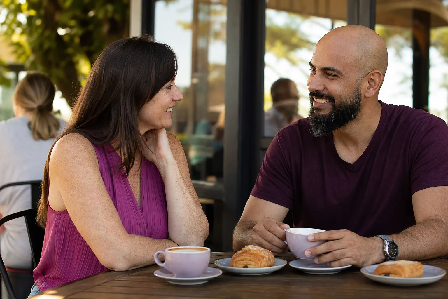 Two people talking over coffee beside Auckland's waterfront